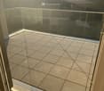 Glass railing, tiled flooring, partial drainage system