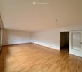 empty room, hardwood floors, white walls, windows with white frames, open door to another room