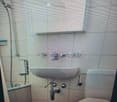 white tiles, shower head, shower curtain, sink, toilet