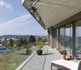 terrace, floor to ceiling glass windows, patio set, view of the cityscape