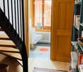 Staircase, hallway, rug, door, toilet, window, radiator, bookshelf with books