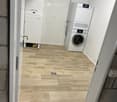 small room with washing machine, dryer, and refrigerator