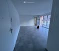 empty room, white walls, tile floor, glass doors leading to a balcony