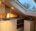 Kitchen with sink, countertop, microwave, fridge, wooden floor, loft