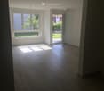 empty room, hardwood floor, open window, sliding door to balcony