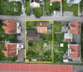 Plot of land, Garages, Cars parked, houses, street, path, garden