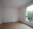 large windows, wooden floor, white walls, no furniture