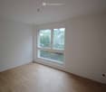 large window, wooden floors, white walls, power outlets
