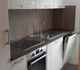 Modern kitchen, stainless steel appliances, gas stove, oven, dishwasher, wooden floor