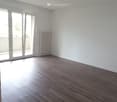 empty room, wooden floor, sliding glass door, balcony, white walls, white radiator