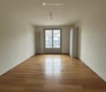 empty room, hardwood floors, two doors, windows, radiator