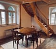 wooden table and chairs, large windows, spiral staircase, wooden flooring, rug, heating