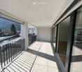 spacious balcony with black railings, panoramic views of mountains and river