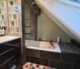 Bathtub, separate shower, vanity, tiled floors, slanted ceiling, window