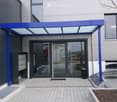 Front entrance with glass doors, mailbox and canopy