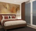 large bed, beige linens, red pillows, small nightstand, wall mural, sliding doors, panoramic view