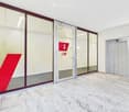 Marble floor, glass doors, elevator, red V sign