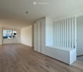empty room, wooden floor, white walls, large window with view, built-in wardrobes, bench, staircase