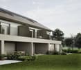 Modern two-story house with solar panels on the roof, balconies, and a garden