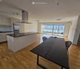 open kitchen, dining table, sliding doors, balcony, wooden floor, appliances