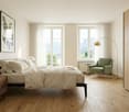 large windows with views, wooden floor, wooden bedside tables, double bed, white linens, armchair, floor lamp