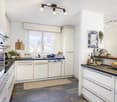 modern kitchen, white cabinets, granite countertops, built-in dishwasher, open concept