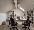Small room with desk, chair, bookshelves, ceiling lamp, globe and light fixtures, wooden floor, sky light