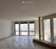 empty room, white walls, large windows, tarpaulin on the floor