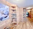 wooden walls, wooden floor, corner shelves, large picture, buddha statue, mirror