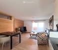 modern interior, wooden walls, dining table, chairs, TV, coffee table, rug, kitchen counter, sculptures
