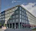 large modern building, glass windows, multiple floors, modern architecture