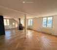 empty room, wooden parquet floor, fireplace, windows, radiators