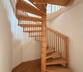 wooden spiral staircase, wooden floor, white walls