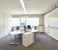empty office room with desks, chairs, cabinets, whiteboard, carpeted floor