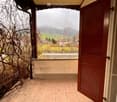 tiled floor, wooden door, balcony, view of mountains and fields
