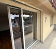 sliding glass doors, balcony, tiled floor, beige walls
