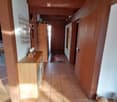wooden beams, tiled floor, wooden cabinet, rug, wooden doors, wall art, light fixtures