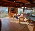 dining room with wooden table, chairs, rug, wooden cabinet, glass windows, wooden ceiling