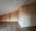 empty room, wooden floor, wooden walls, slanted ceiling