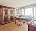 wooden floor, large window, wooden table, wooden cabinet, couch, bowl, painting