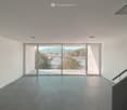 Sliding glass doors leading to a terrace, mountain views, modern design, white walls, gray floors