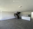 open room, modern style, tiled floor, white walls, kitchen island, glass walls, staircase