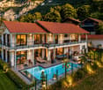 2 story house, brown roof, large windows, swimming pool, terrace, mountain view