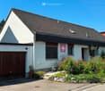 single family house, white paint, brown roof, wooden garage door, garden, flower beds