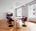 conference room, parquet floor, white desk, chairs, flat screen TV, ceiling lamps