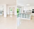 Modern kitchen with white cabinets, granite countertop, and stainless steel appliances. Features large windows and a sliding glass door leading to a balcony.