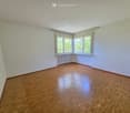 empty room, white walls, wooden floor, large windows, white radiator
