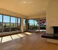 Unfurnished Room. Bright, unfurnished room with large floor-to-ceiling windows, wooden flooring, and a fireplace.