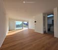 Unfurnished Room. Bright, empty room with wooden flooring, white walls, and large sliding glass doors leading to a balcony. The room has recessed lighting and a view of the outdoors.