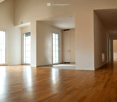 Unfurnished Room. Empty room with polished wooden flooring, large glass doors, and white walls. No furniture or equipment present.